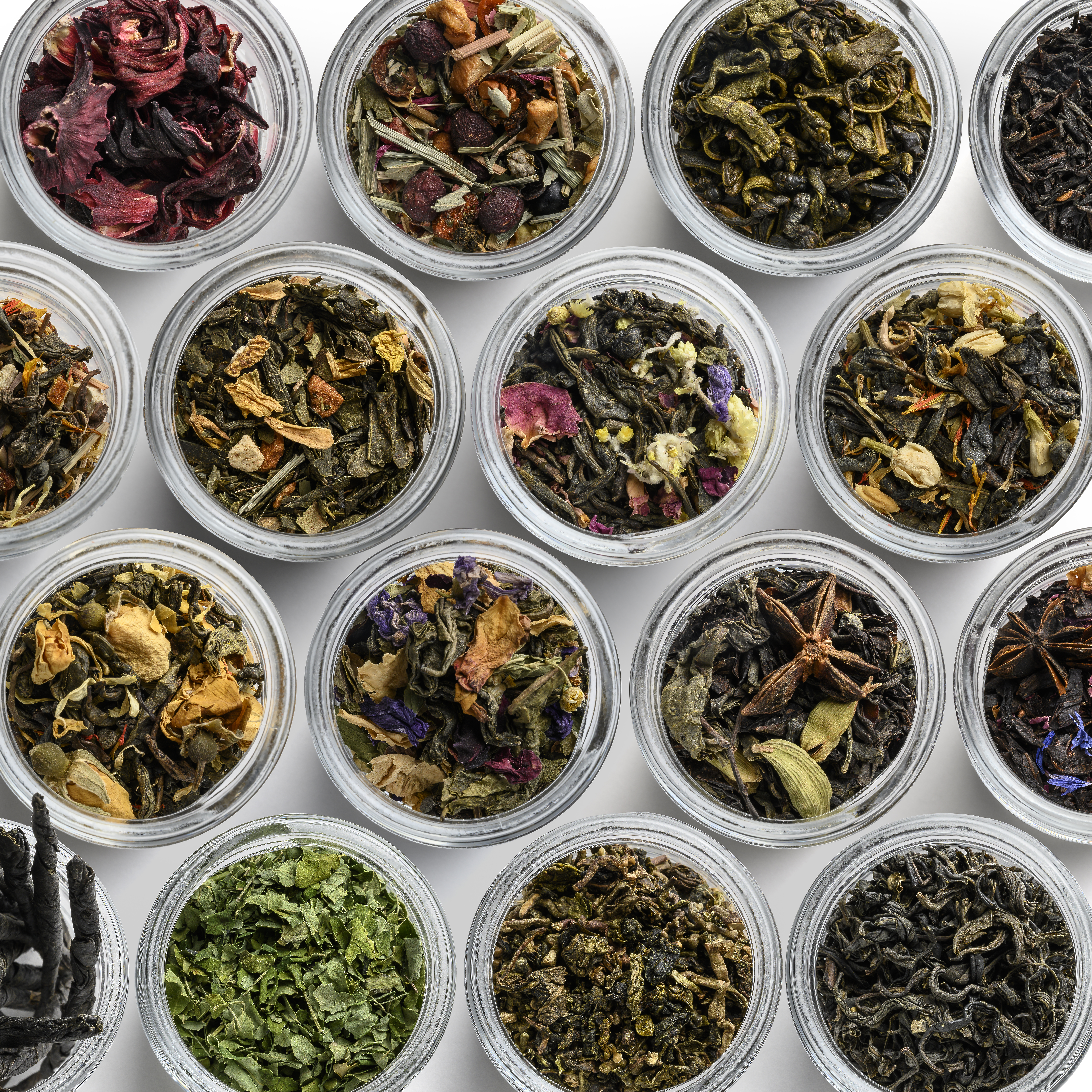 Large assortment of teas in the form of a frame on a white background. The view from the top.